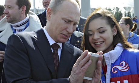 Vladimir Putin looks at a mobile