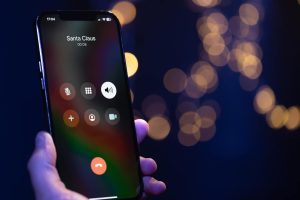 Closeup of an iphone showing a phone call from santa claus