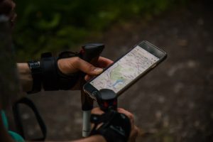 cyclist holding smartphone showing a map