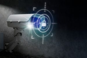 A home security camera in the dark, with a scope and padlock design drawn over it